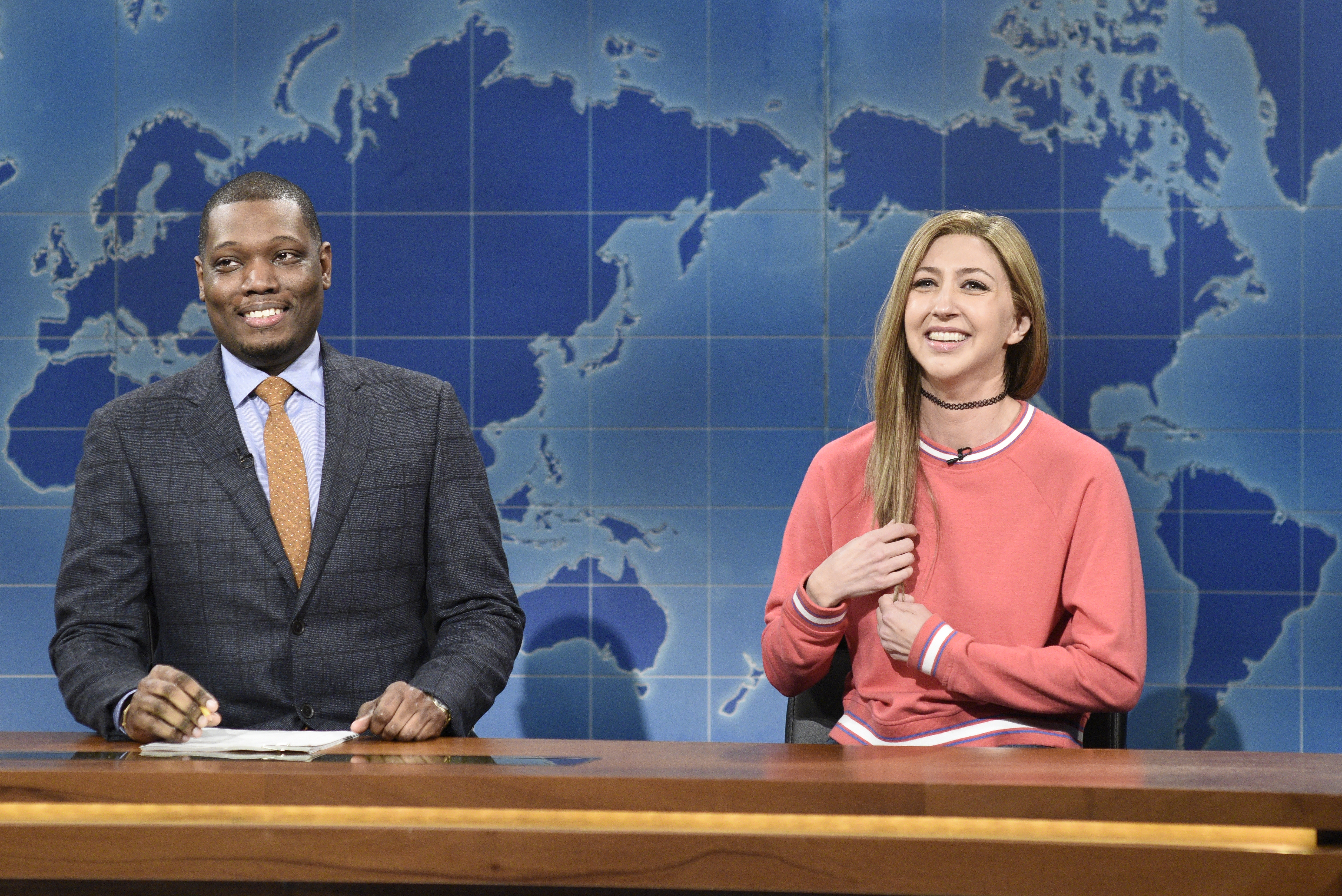 SATURDAY NIGHT LIVE -- "David Harbour" Episode 1770 -- Pictured: (l-r) Anchor Michael Che and Heidi Gardner as Bailey Gismert during Weekend Update on Saturday, October 12, 2019 -- (Photo by: Will Heath/NBC)
