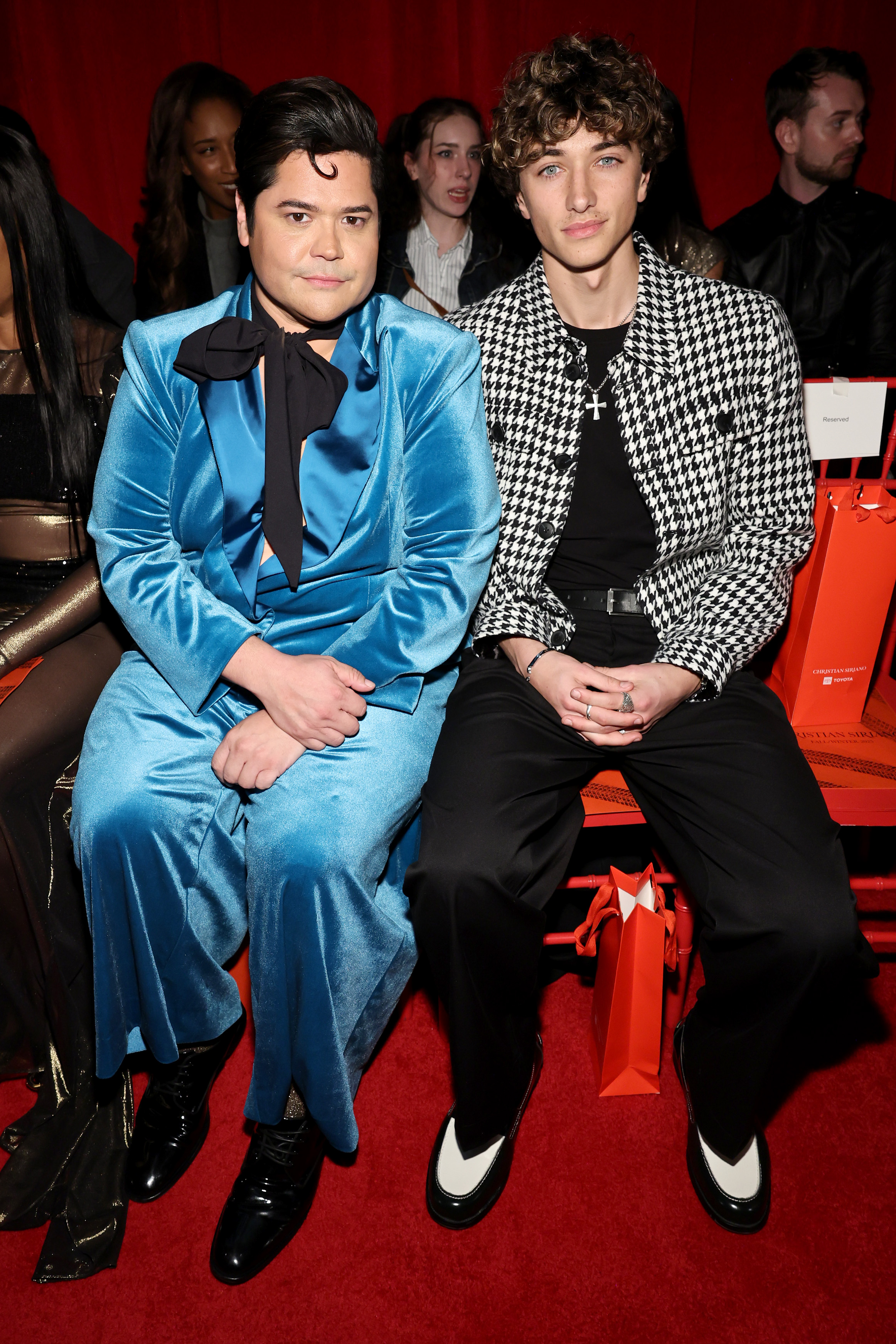 NEW YORK, NEW YORK - FEBRUARY 06: (L-R) Harvey Guillén and Gavin Casalegno attend the Christian Siriano Fall/Winter 2025 runway show at Chelsea Industrial on February 06, 2025 in New York City.  (Photo by Jamie McCarthy/Getty Images for Christian Siriano)