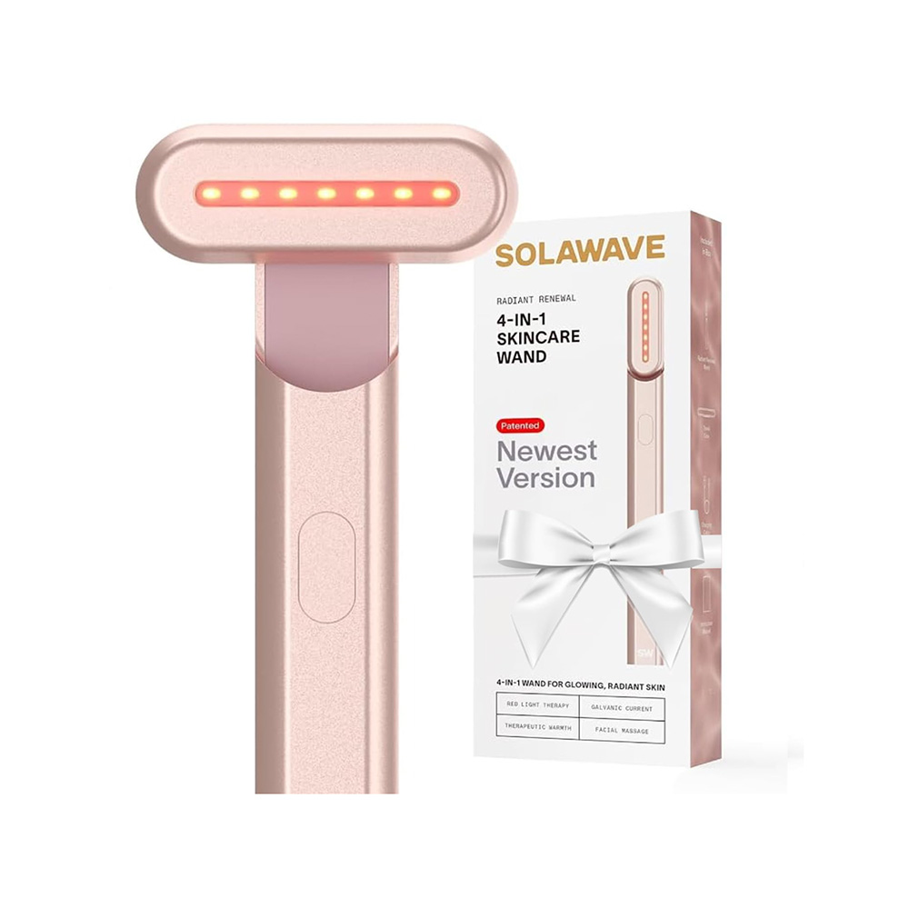 skincare wand in a pale pink hue next to its accompanying packaging
