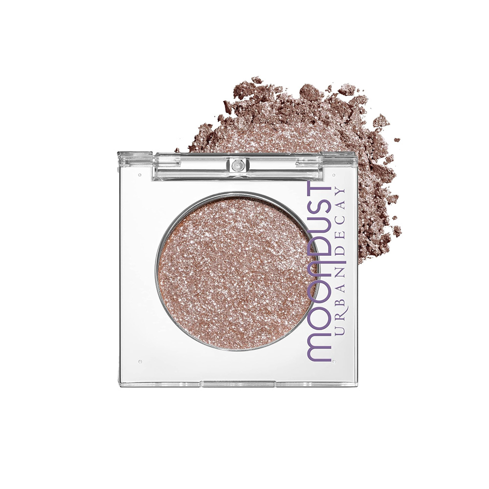shimmering eyeshadow in a reflective container, with crushed eyeshadow underneath