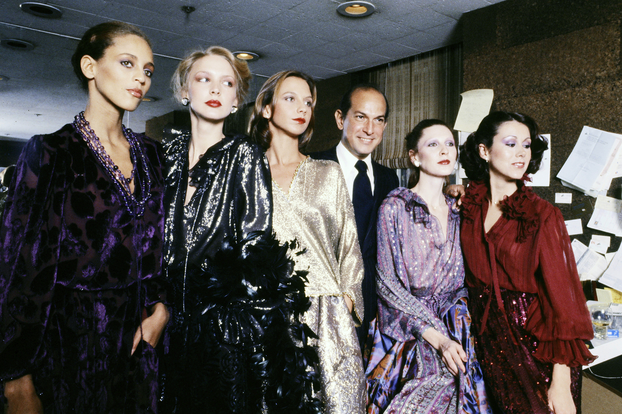 Designer Oscar de la Renta, with models including Alva Chinn and Karen Bjornson, previews his Fall 1977 Ready to Wear Collection, in New York City.