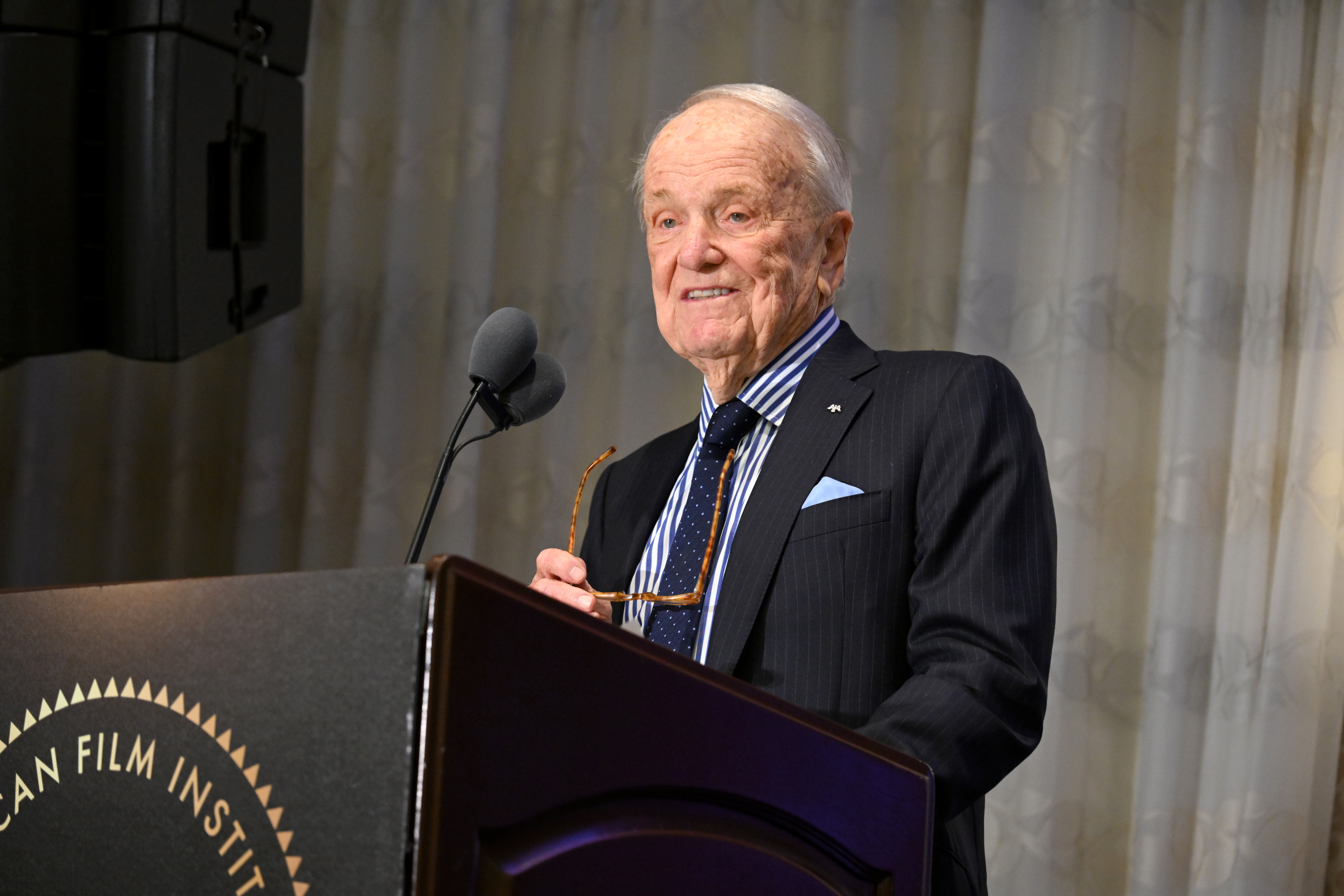 LOS ANGELES, CALIFORNIA - FEBRUARY 06: George Stevens Jr. speaks onstage during the AFI Awards at Four Seasons Hotel Los Angeles at Beverly Hills on February 06, 2025 in Los Angeles, California. (Photo by Michael Kovac/Getty Images for AFI)