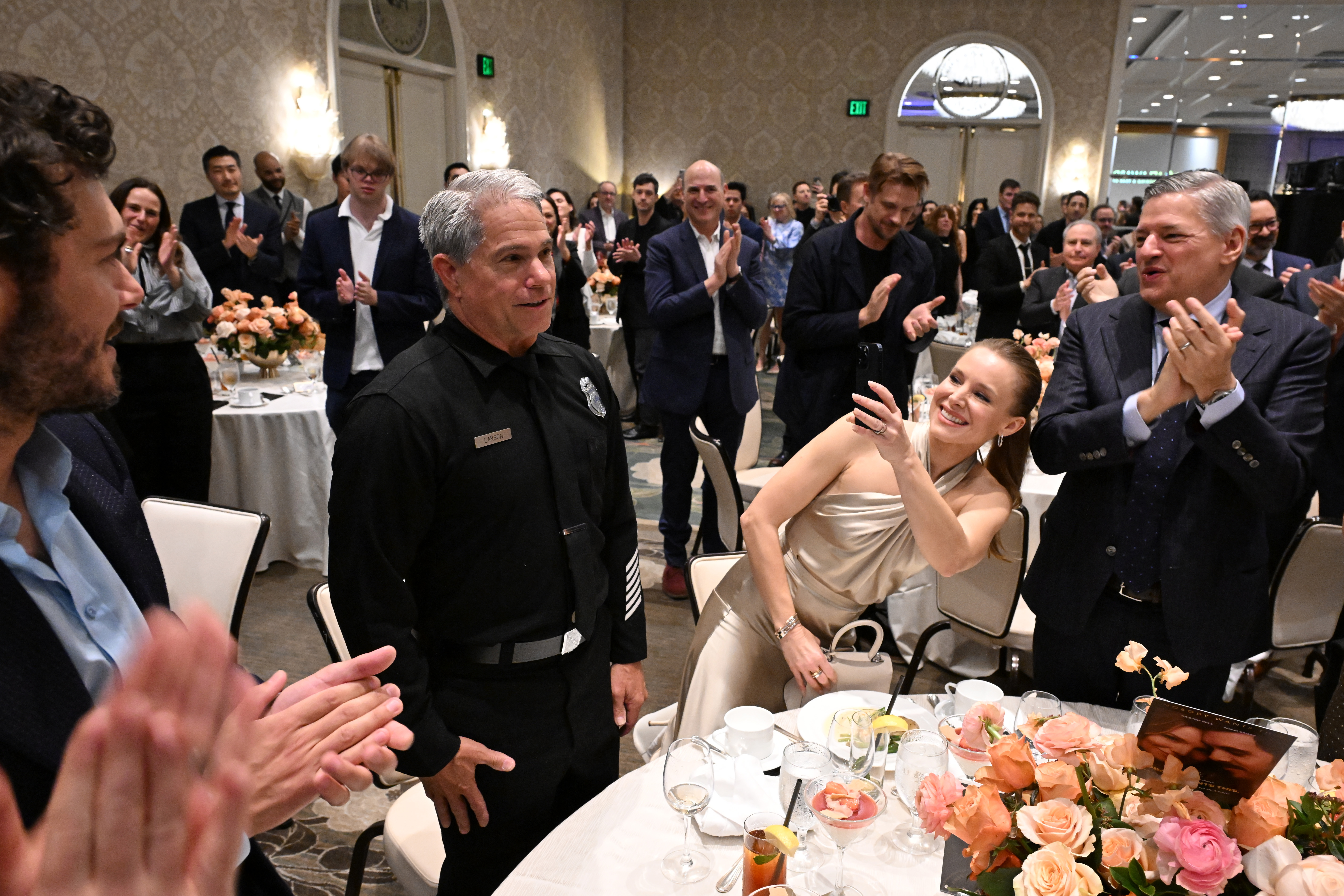 LOS ANGELES, CALIFORNIA - FEBRUARY 06: (L-R) Timmy Larson, Kristen Bell and Ted Sarandos, CEO, Netflix attend the AFI Awards at Four Seasons Hotel Los Angeles at Beverly Hills on February 06, 2025 in Los Angeles, California. (Photo by Michael Kovac/Getty Images for AFI)
