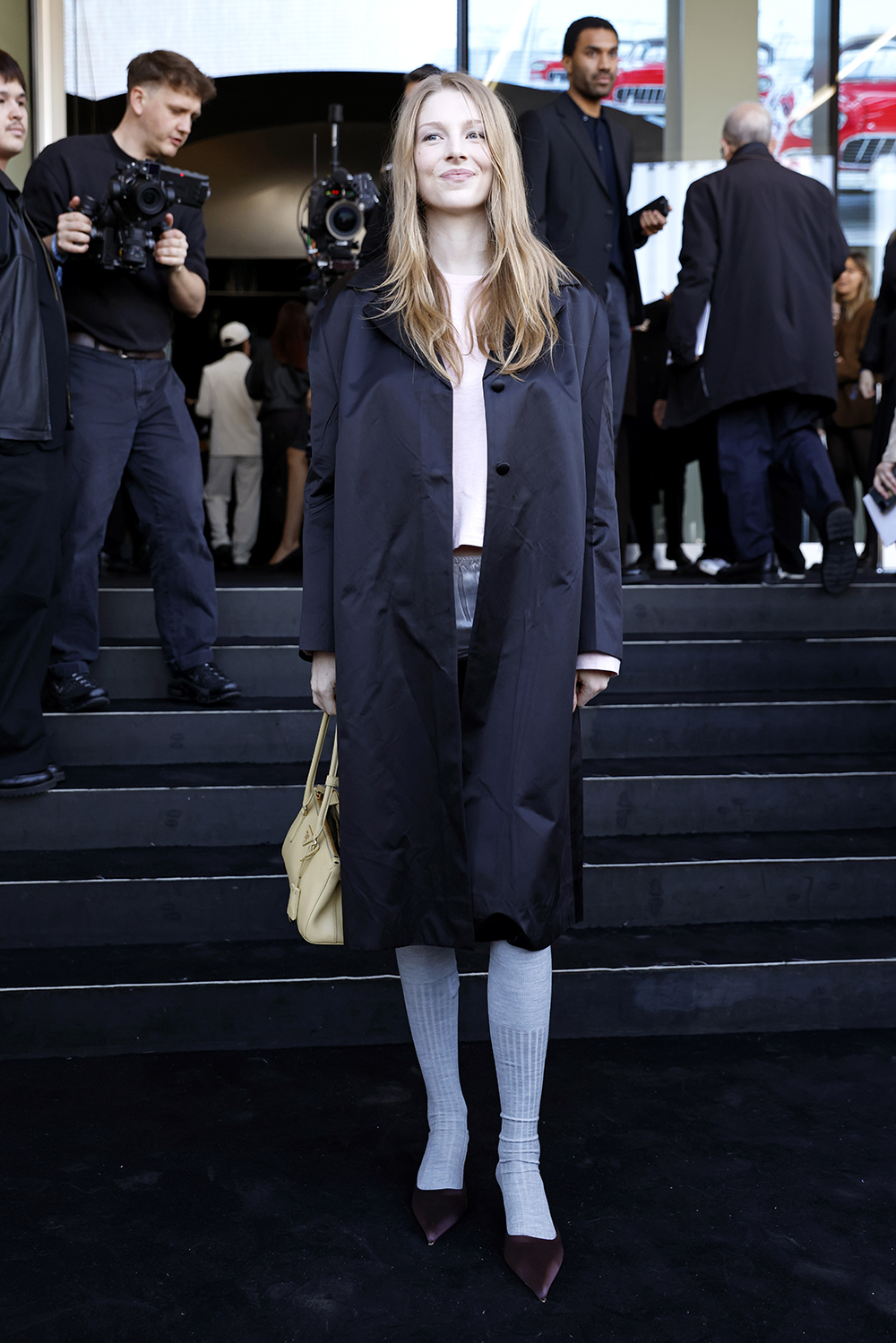 Hunter Schafer arrives at Prada's fall 2025 fashion show in Milan, pastels, front row