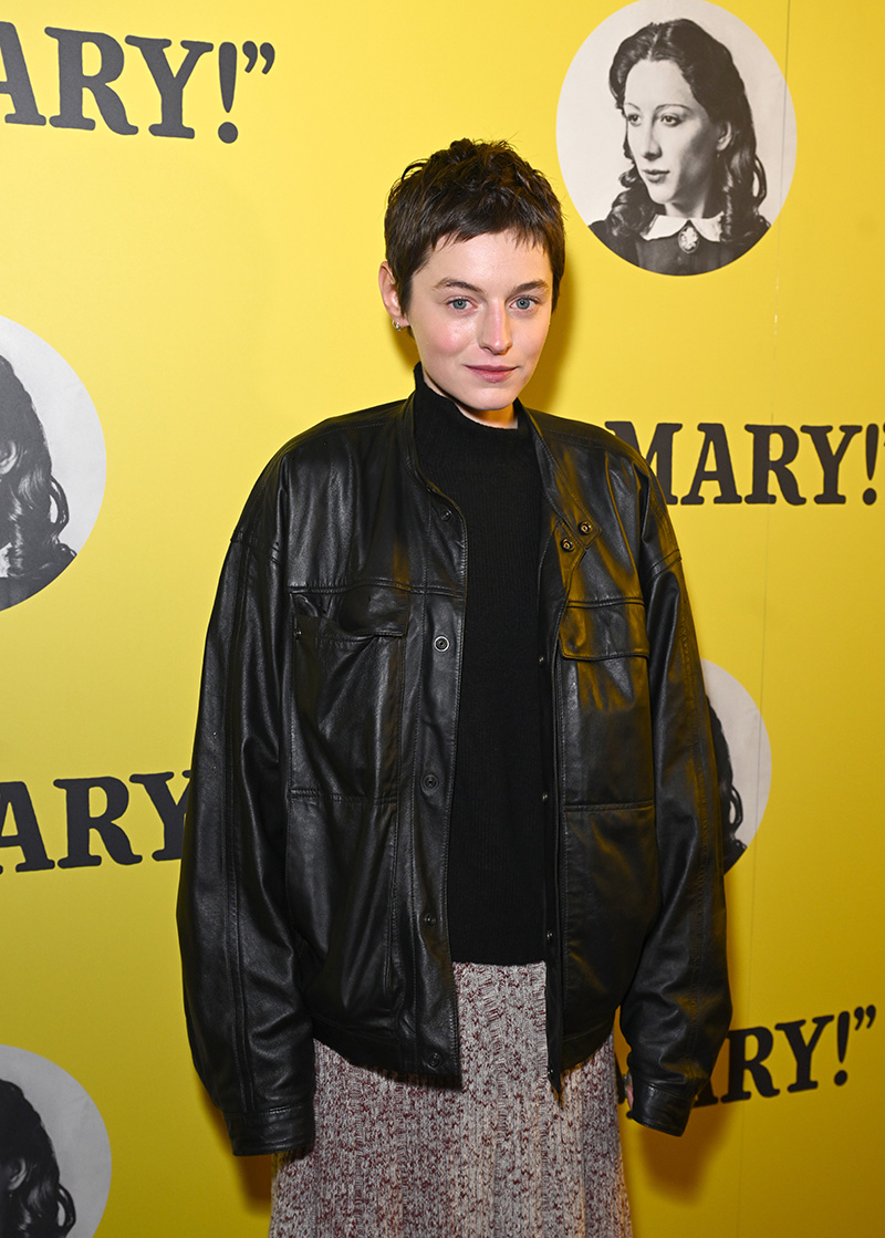 Emma Corrin wears Lemaire leather jacket and wool skirt at the