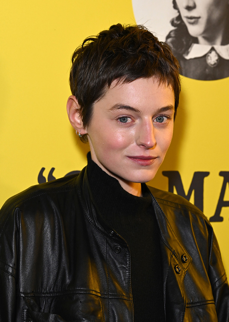 Emma Corrin wears Lemaire leather jacket and wool skirt at the
