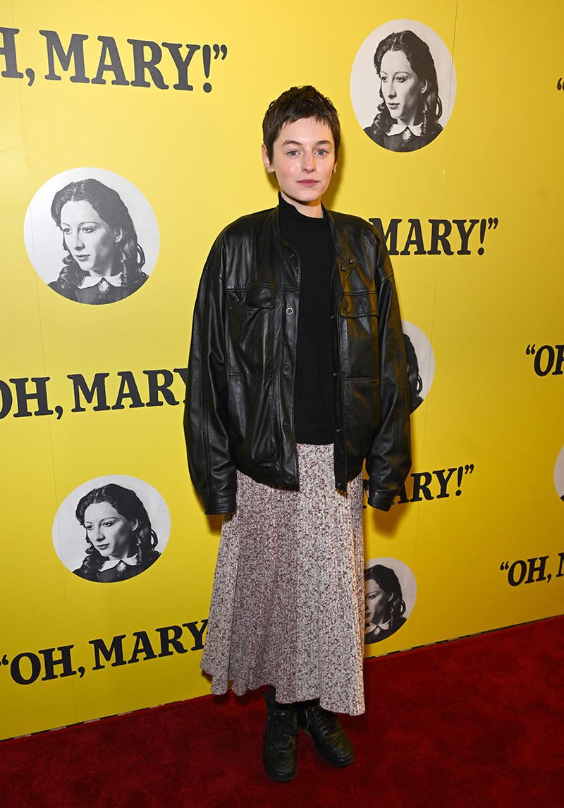 Emma Corrin wears Lemaire leather jacket and wool skirt at the